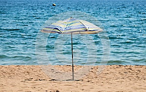 Lonely beach umbrella on the sand.