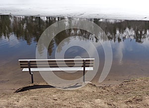 Lonely Bench on Frozen Winter Lakeside