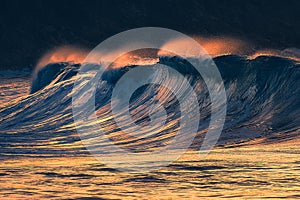 Lonely big wave breaking at sunset