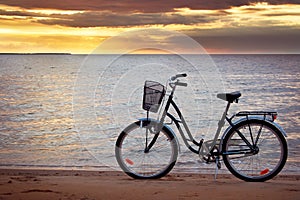 Lonely bike standing at sunset