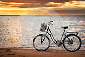 Lonely bike standing at sunset at seaside