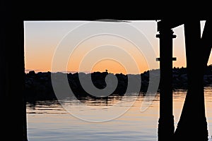 Lonely bird sitting on the stones in sunset