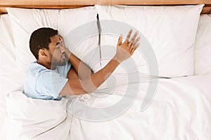 Lonely black man sleeping in bed and missing his partner