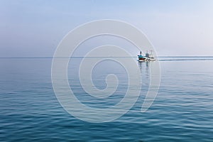 Lonely boat at Andaman blue sea in calm weather, Thailand