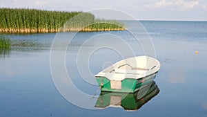 Lonely boat in calm lake water