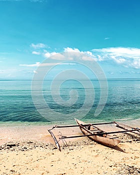 Lonely Boat on an Isolated Beach in Raja Ampat, West Papua, Indonesia