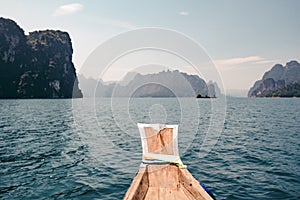 A lonely boat in the ocean between the rocks