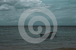 A lonely boat in the sea in Playa Ballenas, Las Terrenas, Dominican Republic photo