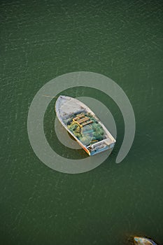 A lonely boat in the sea water vertical photo