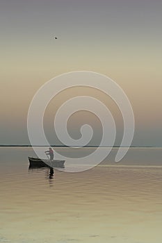 Lonely boat on silent water. sunset