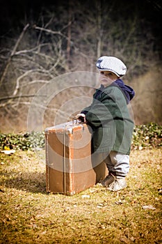 Lonely boy with suitcase