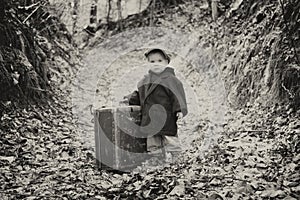 Lonely boy with suitcase, vintage