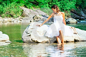 Lonely bride in a rock by the river