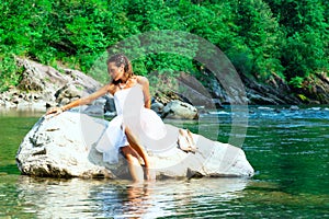 Lonely bride in a rock by the river