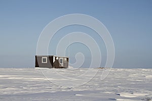 Lonely cabin in a snow landscape on the arctic tundra