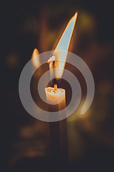 A burning candle on the table