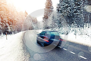 Lonely car driving in winter landscape