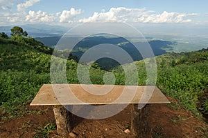 Lonely chair with grass, mountain and cloudy sky view of Chiangmai Thailand