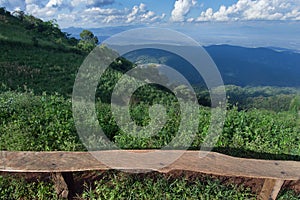 Lonely chair with grass, mountain and cloudy sky view of Chiangmai Thailand