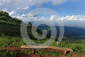 Lonely chair with grass, mountain and cloudy sky view of Chiangmai