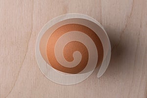 Lonely chicken egg on a wooden background