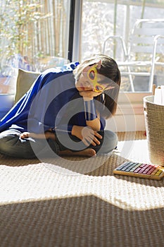 Lonely child dressed up like lockdown superhero feeling depressed, home