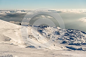 Lonely Cottage high in the Mountain in a snowy Winter Landscape