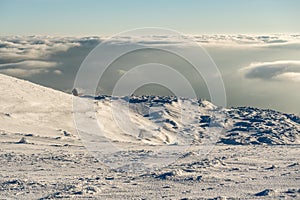 Lonely Cottage high in the Mountain in a snowy Winter Landscape