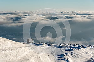 Lonely Cottage high in the Mountain in a snowy Winter Landscape