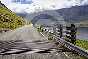 A lonely country road in the Faroe Islands meanders along the ocean