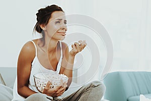 Lonely Crying Woman Is Eating Popcorn On The Bed.
