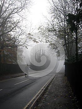 Lonely cyclist on a misty day