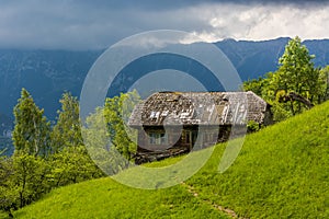 A Lonely Deserted House Surrounded by Green Vegetation and Mountains