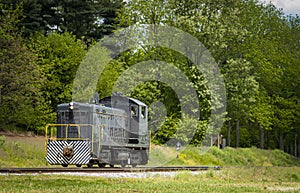 A Lonely Diesel Switcher Traveling Along the Countryside