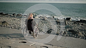 Lonely disabled woman looking at sea