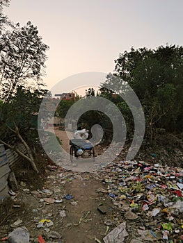 A lonely drifter riding the road of poverty thickly covered with the food garbage photo