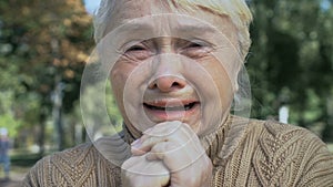 Lonely elderly lady crying thinking of problem, aged widow feeling hopelessness