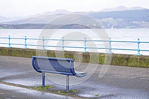Lonely empty bench in open esplanade tranquil space on Scottish west coast town in Greenock