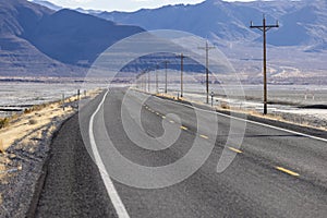 Lonely empty highway stretching for miles into the desert