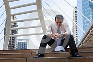 Lonely engineer man lost in a depression sitting on the stair, feeling sad concepts