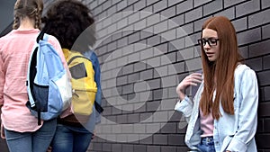 Lonely female teenager leaning wall, new college adjustment, lack of friends