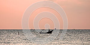 Lonely fisherman`s boat at sunrise