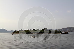 Lonely fishing boat docked in calm lake. wooden fishing boat in a still lake water.