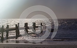 Lonely fishing boat and sea pier in dark ocean, sea.