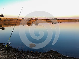 lonely fishing rod on the lake on a clear summer day