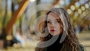 lonely frustrated woman on street in autumn day, blank stare and vacant eyes