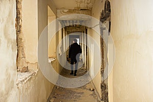 A lonely gay man walkin in the abandoned corridor photo