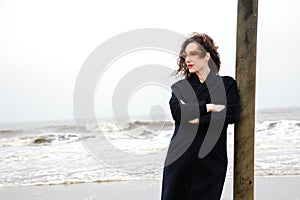 Girl rain sea wind winter portrait woman smile spring coat long hair curly mood shore snow beach autumn deadpan