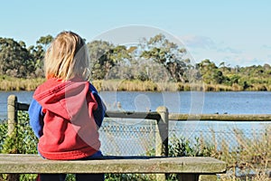 Lonely girl on bench