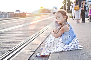 Lonely girl on a city tram station